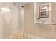 Hallway with tile flooring leading to bathroom area featuring tile walls at 1828 Stratford Ln, Longmont, CO 80503
