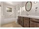 Bright bathroom featuring a bathtub and vanity with drawers at 1828 Stratford Ln, Longmont, CO 80503