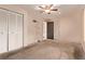 Bedroom with closet and ceiling fan, offering ample storage and comfort at 1828 Stratford Ln, Longmont, CO 80503