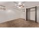 Carpeted bedroom featuring neutral walls, standard closet, and ceiling fan at 1828 Stratford Ln, Longmont, CO 80503