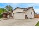 Spacious home exterior featuring an attached garage and lovely landscaping at 1828 Stratford Ln, Longmont, CO 80503
