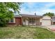 Charming single-story home with brick accents, manicured lawn, and attached garage at 1828 Stratford Ln, Longmont, CO 80503