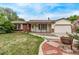 Home exterior with brick accents, front porch and well maintained lawn at 1828 Stratford Ln, Longmont, CO 80503