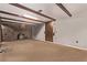 Living room with a brick fireplace and hearth, wood-trimmed ceiling beams, and carpet flooring at 1828 Stratford Ln, Longmont, CO 80503