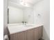 Modern bathroom featuring white countertop, wood cabinets and a large mirror at 822 Fairfax St, Denver, CO 80220
