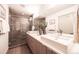 Modern bathroom featuring a double vanity, a glass-enclosed shower, and stylish fixtures at 822 Fairfax St, Denver, CO 80220