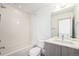 Bright bathroom with shower-over-tub, modern vanity, and white tile at 822 Fairfax St, Denver, CO 80220