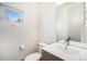Bright half bathroom with a modern vanity, mirror, and a window for natural light at 822 Fairfax St, Denver, CO 80220