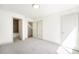 Bright bedroom with neutral carpet, white walls, and ensuite bathroom at 822 Fairfax St, Denver, CO 80220