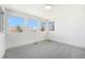 Bedroom featuring neutral carpeting, white walls, and three large windows at 822 Fairfax St, Denver, CO 80220