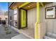 Modern home featuring a vibrant green front door, a brick pillar and contemporary siding and trim at 822 Fairfax St, Denver, CO 80220