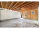 Unfinished garage with a concrete floor and an unfinished ceiling showing the wooden rafters at 822 Fairfax St, Denver, CO 80220