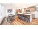 Bright kitchen with stainless steel appliances, island with seating, and adjacent dining area, creating an inviting space at 822 Fairfax St, Denver, CO 80220