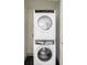 Stacked white washer and dryer in laundry room at 822 Fairfax St, Denver, CO 80220