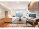 Cozy living room with a modern fireplace, comfortable seating, and a sliding glass door providing natural light at 822 Fairfax St, Denver, CO 80220