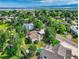 High aerial view of a neighborhood with mature trees and lush landscaping with lake and mountain views at 8165 W Stene Dr, Littleton, CO 80128