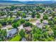 An aerial view of a neighborhood with mature trees and lush landscaping with mountain views in the background at 8165 W Stene Dr, Littleton, CO 80128