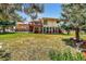 Expansive backyard featuring a deck, manicured lawn, and mature trees, creating a serene outdoor retreat at 8165 W Stene Dr, Littleton, CO 80128
