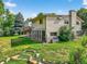 Lush backyard featuring mature trees, a well-manicured lawn, and a charming deck, perfect for relaxation at 8165 W Stene Dr, Littleton, CO 80128