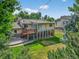 A spacious backyard featuring a patio deck, covered space underneath, and a well-manicured lawn at 8165 W Stene Dr, Littleton, CO 80128