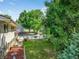 Well-maintained backyard with lush green lawn, beautiful landscaping, and mature trees at 8165 W Stene Dr, Littleton, CO 80128
