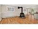 Basement featuring a wood burning stove, hardwood floors, and a sliding glass door to the backyard at 8165 W Stene Dr, Littleton, CO 80128