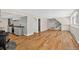 Spacious basement featuring hardwood flooring, a bar area with a wine cooler, and a staircase at 8165 W Stene Dr, Littleton, CO 80128