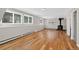 Finished basement with hardwood floors, multiple windows, and a classic wood-burning stove at 8165 W Stene Dr, Littleton, CO 80128