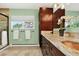 Bathroom vanity with copper sink, granite countertop and green walls at 8165 W Stene Dr, Littleton, CO 80128