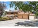 Inviting two-story home with a charming facade, large driveway, and solar panels on the roof at 8165 W Stene Dr, Littleton, CO 80128