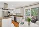 Inviting kitchen with stainless appliances, granite counters, and a sliding door to deck at 8165 W Stene Dr, Littleton, CO 80128