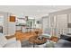 Open-concept living room with wood floors, an island kitchen, and lots of comfortable seating at 8165 W Stene Dr, Littleton, CO 80128