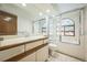 Classic bathroom with a white vanity, a glass-enclosed shower, and a unique stained glass window at 10729 Kipling Way, Broomfield, CO 80021