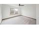 Bright bedroom with a large window and neutral carpeting at 10729 Kipling Way, Broomfield, CO 80021