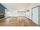 Spacious living room with hardwood floors, large bay windows, and a cozy fireplace at 10729 Kipling Way, Broomfield, CO 80021