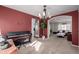 Elegant dining room with modern chandelier, piano, and an arched entry to living space at 10722 W 54Th Pl, Arvada, CO 80002