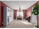 Elegant dining room with red walls, white shelving, and a chandelier for a warm ambiance at 10722 W 54Th Pl, Arvada, CO 80002