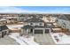 Two-story house with gray siding, three-car garage, and backyard at 11633 Norfolk St, Commerce City, CO 80022