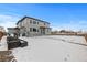 Two story home with backyard, partially covered in snow at 11633 Norfolk St, Commerce City, CO 80022