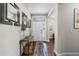 Entryway with wood floors, white door and decorative mirrors at 11633 Norfolk St, Commerce City, CO 80022