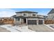 Two-story house with gray siding, three-car garage, and landscaping at 11633 Norfolk St, Commerce City, CO 80022