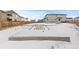 Unfinished concrete foundation in snowy lot at 11633 Norfolk St, Commerce City, CO 80022