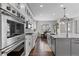 Modern kitchen with white cabinets, center island, and stainless steel appliances at 11633 Norfolk St, Commerce City, CO 80022