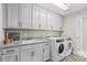 Laundry room with washer, dryer, and cabinets at 11633 Norfolk St, Commerce City, CO 80022