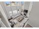 High-view of a bright living room with a stone fireplace and large windows at 11633 Norfolk St, Commerce City, CO 80022