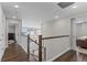 Upstairs hallway with hardwood floors and views to the living room below at 11633 Norfolk St, Commerce City, CO 80022