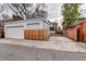 Backyard featuring a detached two car garage and paved parking at 925 N Emerson St, Denver, CO 80218