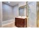 Bathroom with a jacuzzi tub, vanity and shower with glass doors at 925 N Emerson St, Denver, CO 80218