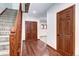Spacious entryway featuring hardwood floors, staircase with wood railing, and closet storage at 925 N Emerson St, Denver, CO 80218