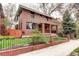 Charming red brick home with a welcoming front porch and well-maintained lawn at 925 N Emerson St, Denver, CO 80218